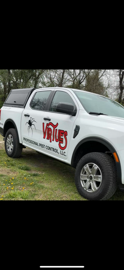pest control truck parked in front of trees